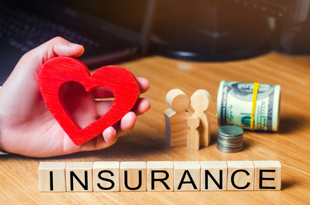 concept medical insurance, family, children, life insurance. heart in the hands of a businessman. dollars, coins and family.の写真素材