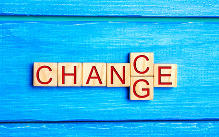 Wooden cube with word "change" to "chance" on wood table. Personal development and career growth or change yourself concept. concept of motivation, goal achievement, potential, incentive, overcomingの写真素材