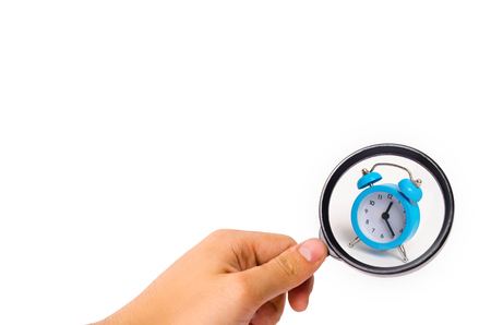A blue alarm clock on a white background. The concept of time and planning. The past, the future and the present. Minimalism. Free or business hours. Life expectancy. Abstraction of time.の写真素材