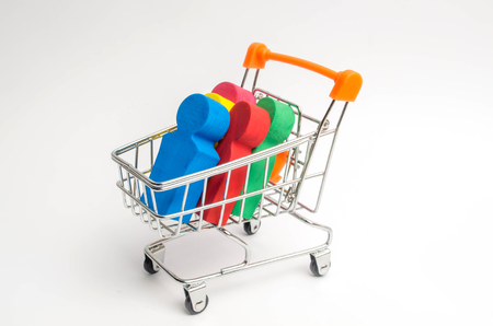 Colored people in a trolley for a supermarket. Concept of human trafficking, modern slavery. Buying people is a violation of international laws. Freedom and respect for human rights.の写真素材
