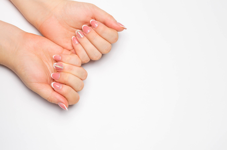Female soft hands with beautiful french manicure. isolated white background. long nails. place for text. copy spaceの写真素材