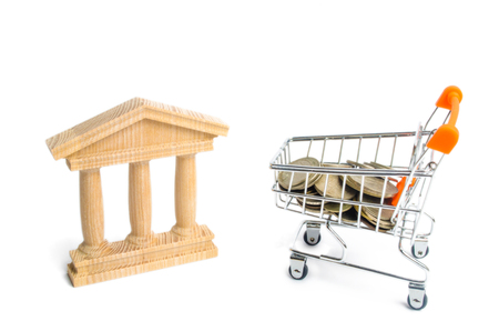 bank and the trolley with money. The concept of dividend payments, deposits in banks. Banking system, investment in the economy. Refusal of small denominations, devaluation. Profit growthの写真素材