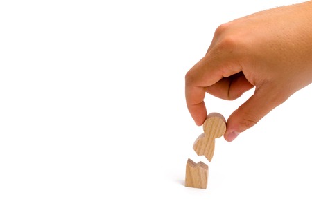 The hand collects the broken human figure. Psychological assistance to victims from physical violence and stress. Rehabilitation and healing of mental wounds. A new life for people with special needs.の写真素材