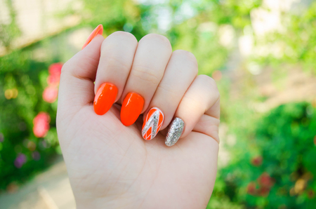 Perfect manicure and natural nails. Attractive modern nail art design. Orange autumn design. Long well-groomed nailsの写真素材