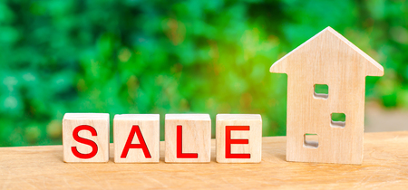 wooden house with the inscription "sale". sale of property, home, real estate. affordable housing.の写真素材