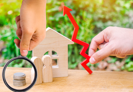 wooden house, money with a red arrow up. concept of high demand for real estate. rise in house prices. population growth. increase in the cost of utilities. property.の写真素材