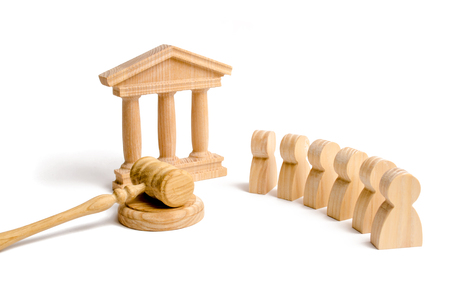A group of people standing near the house of government and judge's gavel. concept of the judicial system and the legislature. Law ceative apparatus. Courthouse, bank. State political system.の写真素材