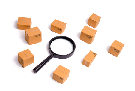 Cardboard boxes and a glass on a white background. The concept of packing goods, sending orders to customers. Warehouse of finished products and equipment. Moving to another house.の写真素材