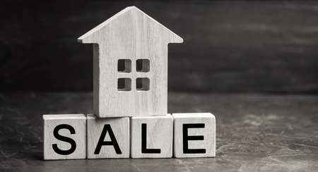 wooden house with the inscription "sale". sale of property, home, real estate. affordable housing.の写真素材