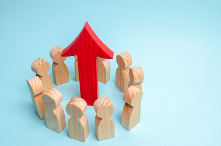 A business team is standing in a circle and the arrow is between the employees. The concept of a startup. Successful business growth. Qualification and retraining of workers. Starting a new projectの写真素材