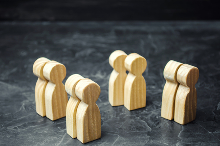 Groups of wooden people. The concept of market segmentation. Marketing segmentation, target audience, customer care. Market group of buyers. Customer analysis and customer relationship managementの写真素材