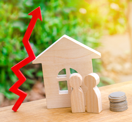 wooden house, money with a red arrow up. concept of high demand for real estate. rise in house prices. population growth. increase in the cost of utilities. property.の写真素材