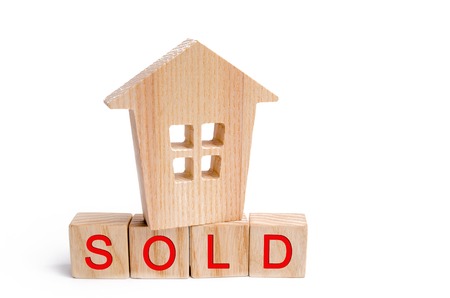 wooden house with the inscription sold on white isolated background. sale of property, home. affordable housing. sale of apartments. real estate agent services.の写真素材
