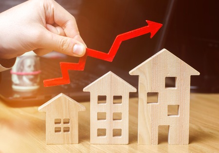 The concept of real estate market growth. The increase in housing prices. Rising prices for utilities. Increased interest in mortgage and rising interest rates on mortgages. focus on the houseの写真素材