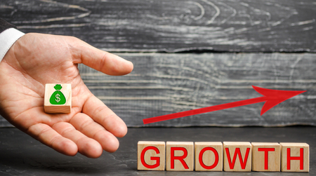 The Inscription Growth and up arrow.The concept of a successful business. Increase in income, salary. The growth of the company's budget. Increased investment spending, economy and finance.の写真素材