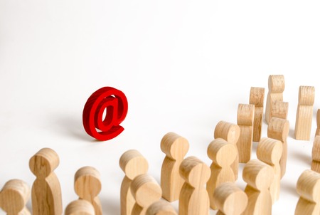 A large crowd of people looking at an email icon on a white background. The concept of e-mail and the Internet, communication and communication. Firewall, Internet restriction and censorshipの写真素材