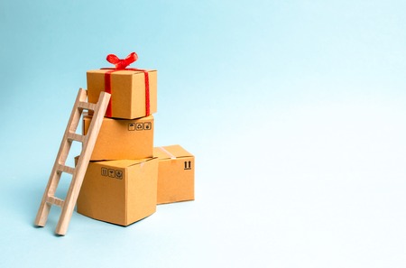 A gift box on a pile of boxes. The concept of finding the perfect gift. Limited offer Buy a gift on...