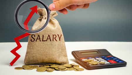 Bag with money and word Salary and up arrow with calculator. increase of salary, wage rates. promotion, career growth. raising the standard of living. increase profits and family budget.の写真素材