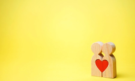 A couple in love and a heart between them. The concept of love and sympathy between two people....
