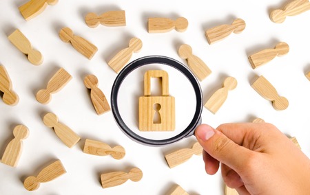 Magnifying glass is looking at the People and padlock on a white background. Safety and alarm...