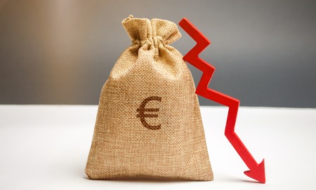 Money bag with a euro sign and an arrow down. The concept of reducing profits. Drop in revenue. Low salary. Financial and economic crisis. Recession family budget. Unsuccessful business.の写真素材