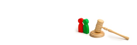 Two men and a hammer of the judge. The trial of cases in court, the resolution of a dispute between two people. Business relations, ascertaining the ownership of property. Litigation. bannerの写真素材