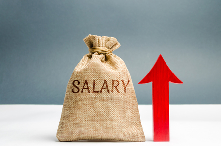 A bag with money and the inscription Salary and up arrow. increase of salary, wage rates. promotion, career growth. raising the standard of living. increase profits and family budget.の写真素材