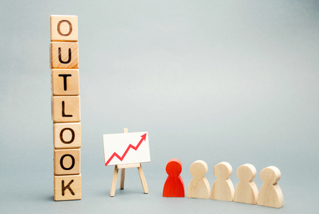 Wooden blocks with the word Outlook, business schedule and a team with a leader. Successful forecast and successful business. Concept perspectives in business. Analytics goal and long-term action planの写真素材