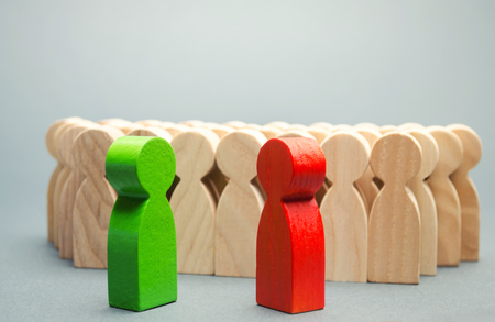 Red and green people stand in front of a crowd. Two opponents. Conflict of interest. Dispute. Search for compromises. Social problems. Business competition. Candidates Political Debateの写真素材