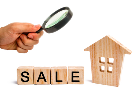 wooden house with the inscription sale on white isolated background. sale of property, home. affordable housing. sale of apartments. real estate agent services.の写真素材