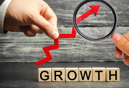 The Inscription Growth and up arrow. The concept of a successful business. Increase in income, salary. The growth of the company's budget. Increased investment spending, economy and finance.の写真素材