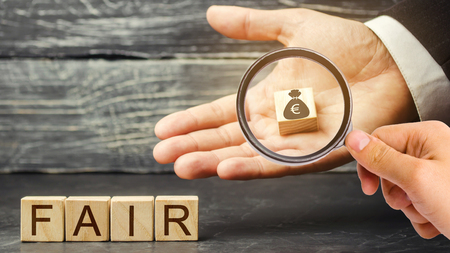 Euro money bag and wooden blocks with the word Fair. Fair value pricing, money debt. Business deal and investment analysis. Fair deal. Reasonable price. Justified risk. Honest loan. Secured loans.の写真素材