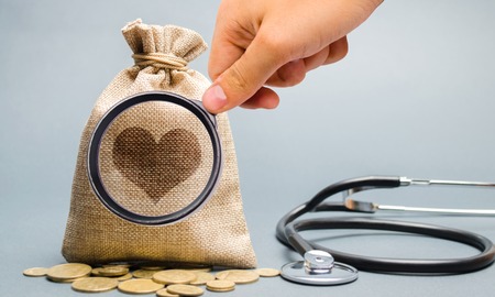 Money bag and heart image with stethoscope. The concept of medical insurance of life, family, health. Healthcare. The accumulation of money. Saving. Coinsの写真素材