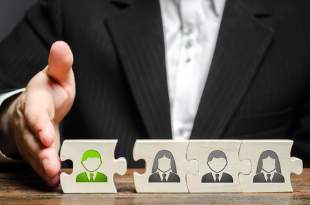 A businessman joins a new employee to the team as its leader. Hiring new employees for the project., teamwork. leader works with the team as a member. increasing efficiency, confidence, communicationの写真素材