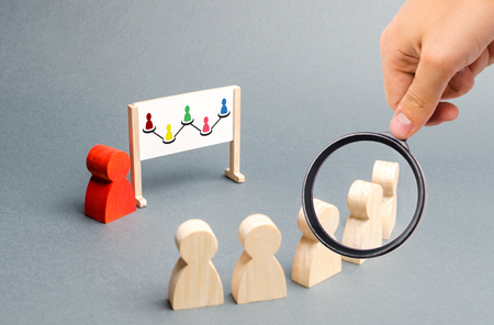 Magnifying glass is looking at the Employees stand in a row at the briefing. Business collection, information on whiteboard. Report and strategy development, building an algorithm. Selective focusの写真素材