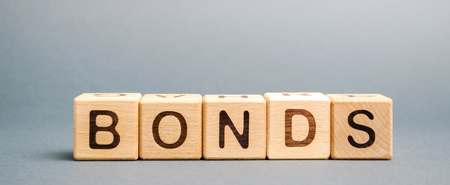 Wooden blocks with the word Bonds. A bond is a security that indicates that the investor has provided a loan to the issuer. Equivalent loan. Unsecured and secured bondsの写真素材