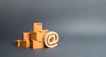 Pile of cardboard boxes and symbol commercial AT. shopping online. E-commerce. sales of goods and...