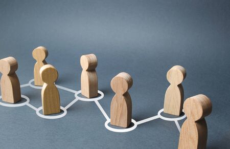 Chain of people figurines connected by white lines. Cooperation and interaction between people and employees. Dissemination of information in society, rumors. Communication. social contactsの写真素材