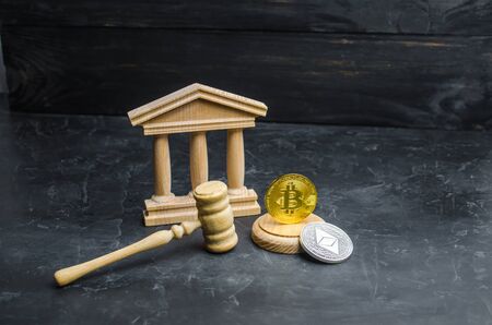 Bitcoin and the courthouse. The concept of legalization of Bitcoin and cryptocurrency based on blockchain technology. Decentralization of cash payments, anonymity. Selective focusの写真素材