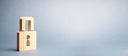 A padlock on a gray background. information safty. concept of the preservation of secrets, information and values. Protection of data. Hacking attack, hacking. banner, place for text. Selective focusの写真素材