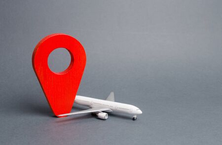 Red position pin and passenger airliner. Air travel and tourism, travel. Destination point. Free movement around the world and visa-free travel. airmail. Fast delivery of goods and products.の写真素材