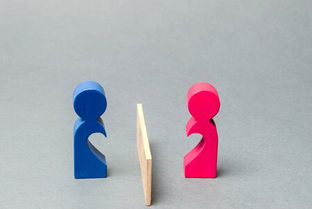 A couple of lovers divided barrier. Concept of breaking relationships, parting and quarrel. Family psychologist services. Divorce and division of property. Minimalism. Love at a distanceの写真素材