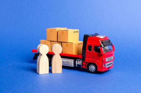 A red truck loaded with boxes near a customer buyer and seller. Business and commerce. Negotiations on supply of goods. Services transportation of goods and products, logistics Transportation company.の写真素材