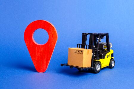 Yellow Forklift truck carries a box next to red pointer location. Services transportation of goods, products, logistics and infrastructure. Transportation company. Location of carriers trackingの写真素材