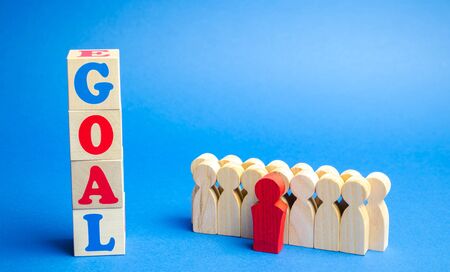 Wooden blocks with the word Goal and business team. Planning financial goals in a company. Business strategy. Cooperation and teamworkの写真素材