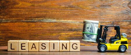 Forklift truck carries a bundle of dollars to inscription Leasing. Lending to businesses, state enterprises and institutions. Financial services to stimulate modernization and economic transformation.の写真素材