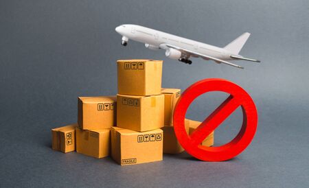 Cargo plane, many boxes and red prohibition symbol NO. Embargo trade wars. Restriction on importation, ban transit export dual-use goods to countries under sanctions. transport companies.の写真素材