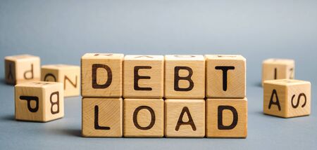Wooden blocks with the word Debt load. The total amount of debt that a company has on its balance sheet. Financial performance of the company. Business and Financeの写真素材
