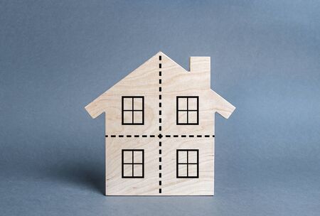 Residential building divided by a dotted line into four equal parts. Divorce concept. Disputes over division process of real estate and property after divorce. Distribution of the rightの写真素材