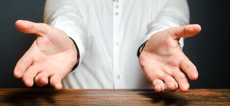 A man holds out his hands in an emotional expression of amazement. Show the cause of grief or surprise. Trying to hug. Blaming an opponent. Introducing something new.の写真素材